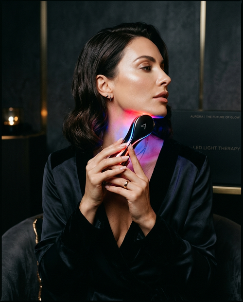 The Lift Device — woman using LED face and neck massager, PORÉ
